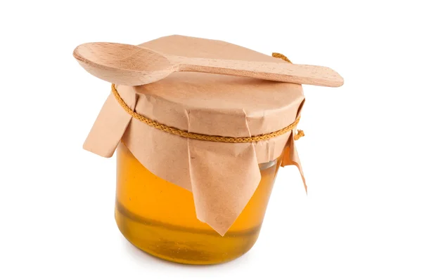 Honey in jar, wooden spoon, close up, isolated. — Stock Photo, Image