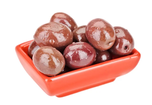 Brown pickled olives fruits in red square plate isolated on whit — Stock Photo, Image