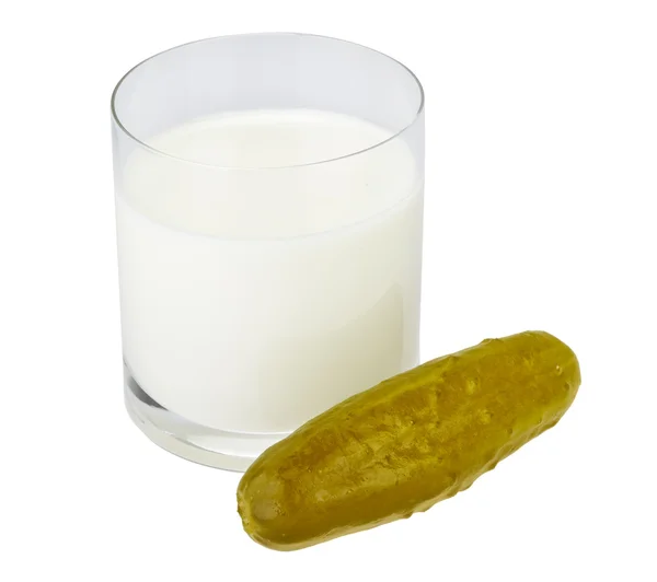 Incompatible eating products milk and salted cucumber — Stock Photo, Image