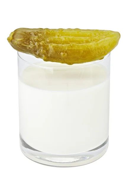 Incompatible eating products milk and salted cucumber Stock Image