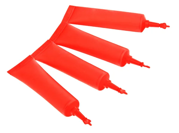 Red cosmetics cream tubes isolated on white — Stock Photo, Image