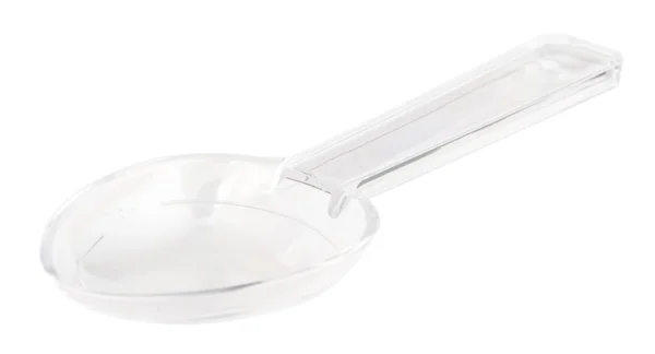 Piccolo cucchiaio dosatore di plastica trasparente isolato su bianco — Foto Stock