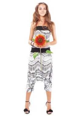 Young beautiful lady in harem pants with sunflower full-length s clipart