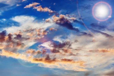 Cumulus clouds on sunset sky background clipart