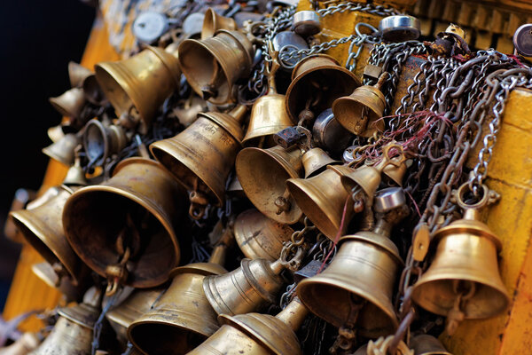 Many metal sacrificial bells hanging on chain, Kathmandu, Nepal