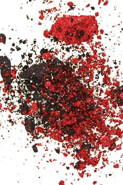 Red and black color crumbled eye shadows isolated on white — Stock Photo, Image