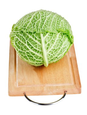 Fresh green cabbage head on wooden chopping board over white bac clipart