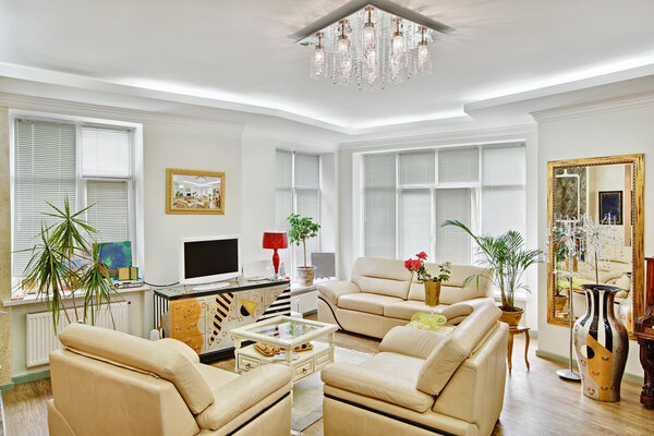 Modern art deco style drawing-room interior with beige leather furniture and TV