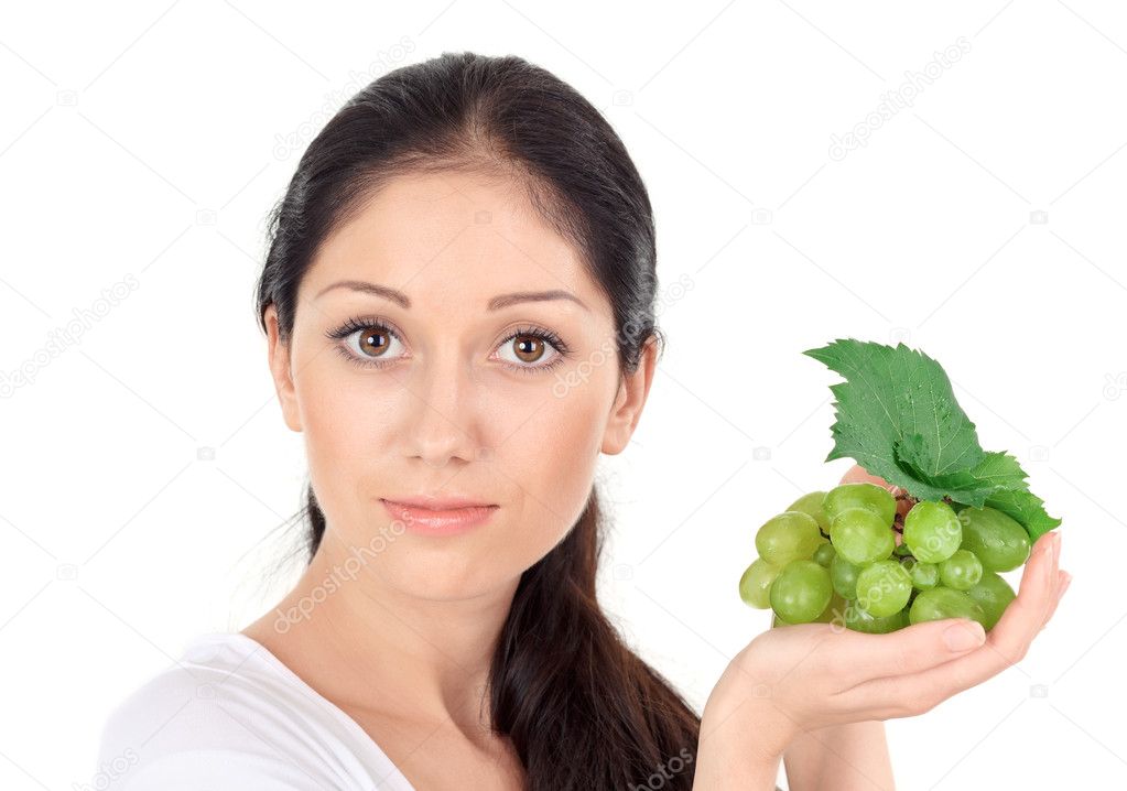 Young attractive woman with green grape cluster isolated on white
