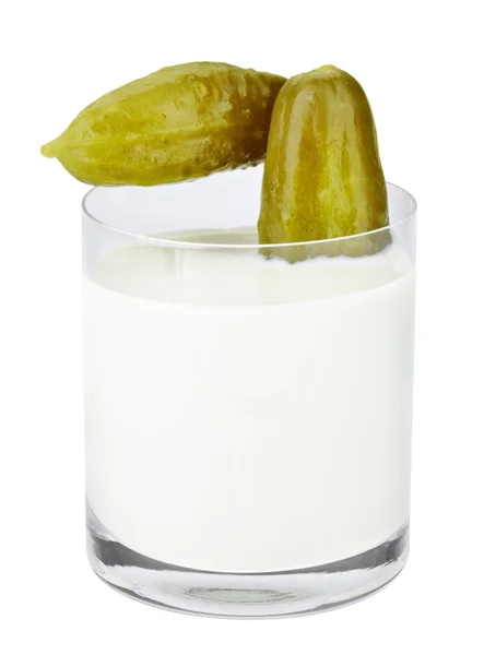 Incompatible eating products milk and salted cucumber — Stock Photo, Image