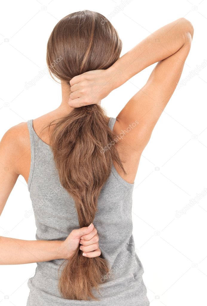 Brunette lady holding long hairs, view from back side isolated o