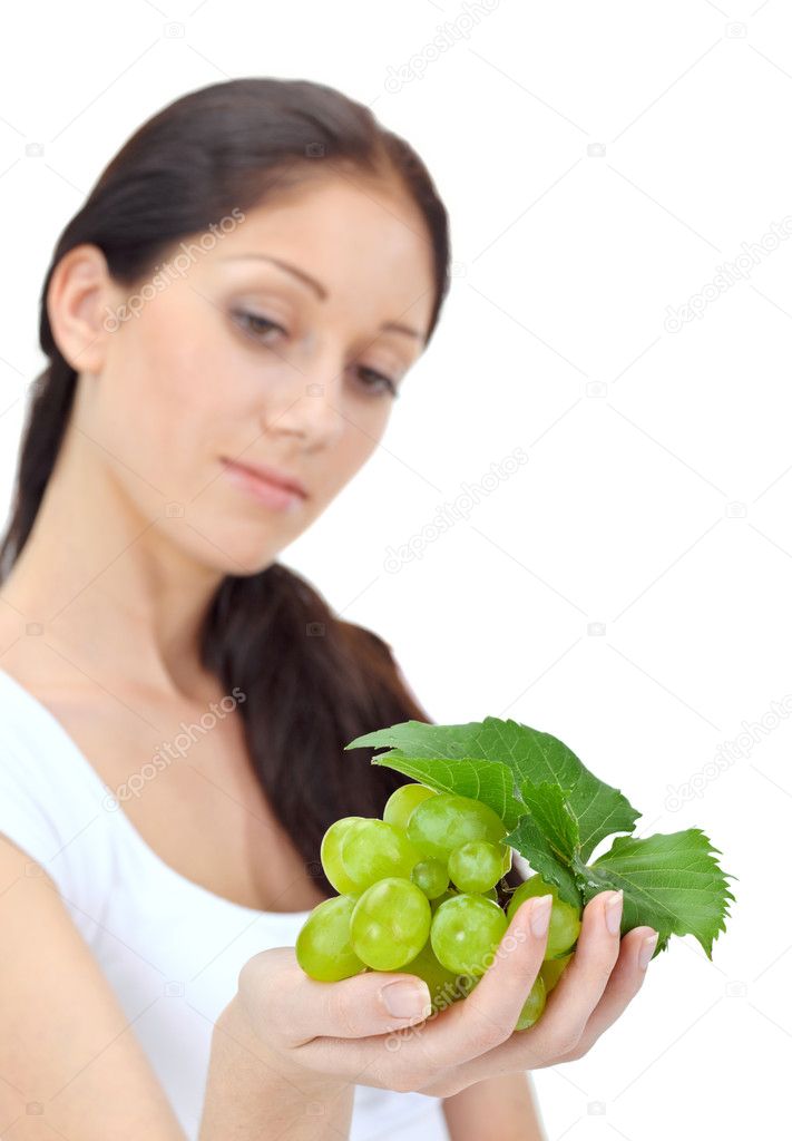 Young attractive woman with green grape cluster