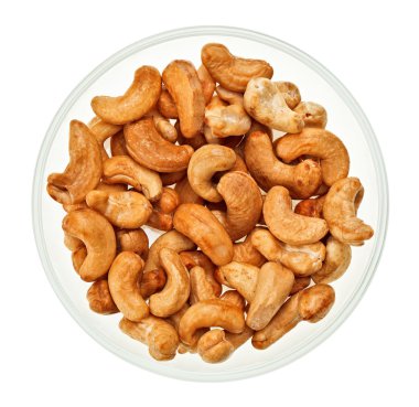 Unshelled cashew nuts in a glass bowl isolated on white