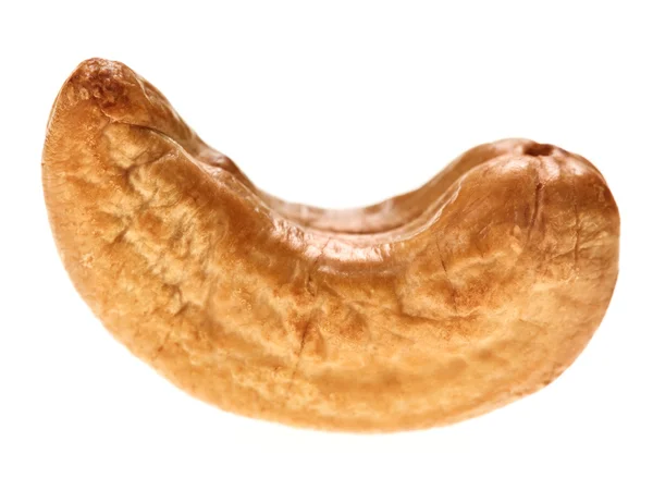 Una nuez de anacardo tostada sin cáscara, aislada en blanco — Foto de Stock