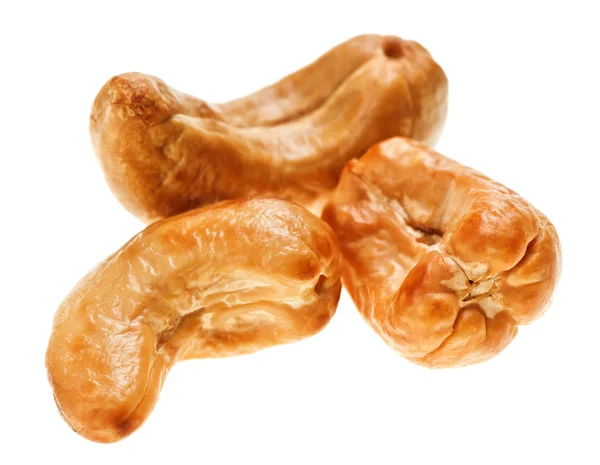 Three unshelled roasted cashew nuts — Stock Photo, Image