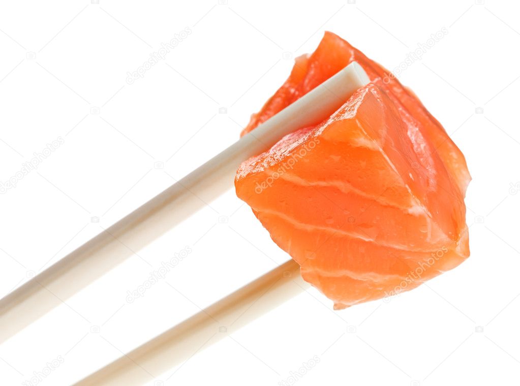Slice of red salmon fish in chopsticks