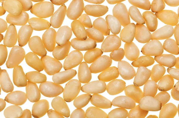 Oskalade pinjenötter isolerad på vit, mat bakgrund — Stockfoto