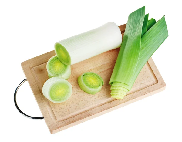 Cross-section of green leek on wooden chopping board — Stock Photo, Image
