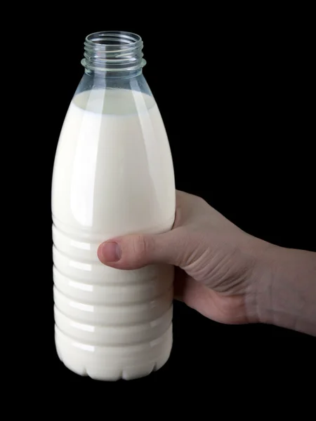 Hand holding milk bottle — Stock Photo, Image