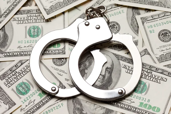 Handcuffs on dollar currency — Stock Photo, Image