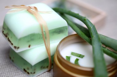 Handmade soap bars, aloe, vera leaves and moisturizer. clipart