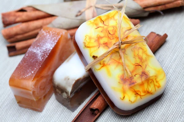 Handmade soap and cinnamon sticks spa composition — Stock Photo, Image