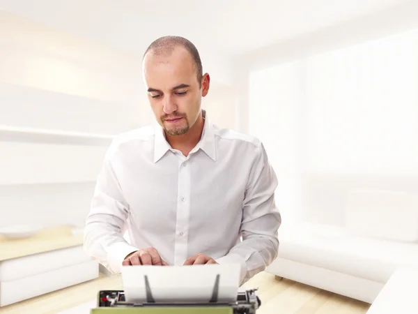 Homem com máquina de escrever em casa — Fotografia de Stock