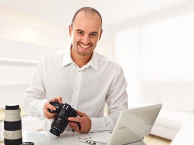 Man with camera at home clipart