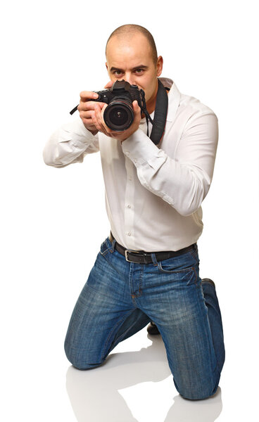 Young photographer at work isolated on white background