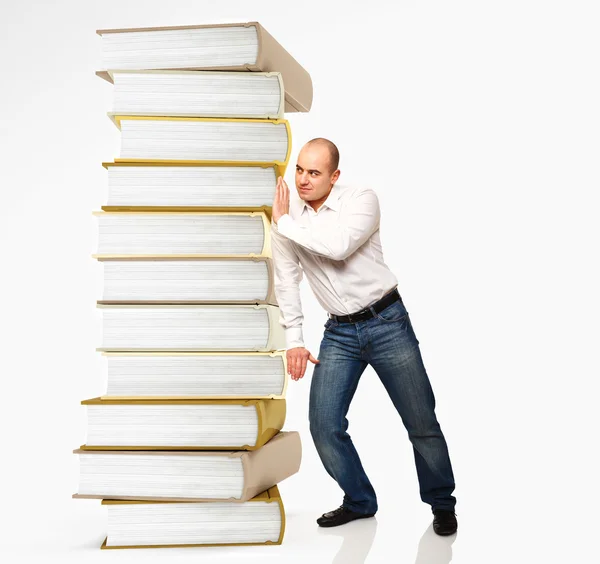 Man push boek stapel — Stockfoto