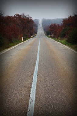 view of long lonely street in puglia, italy clipart