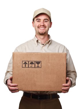 smiling delivery man holding a big parcel isolated on white