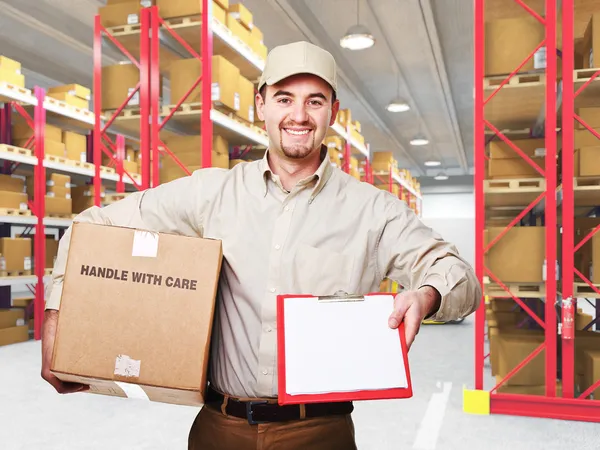 Delivery man in warehouse — Stock Photo, Image