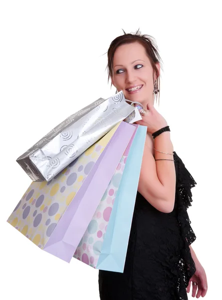 Ung kvinna med shoppingväskor på vitt — Stockfoto