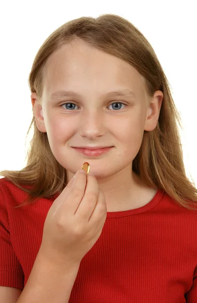 Menina jovem tomando uma pílula — Fotografia de Stock