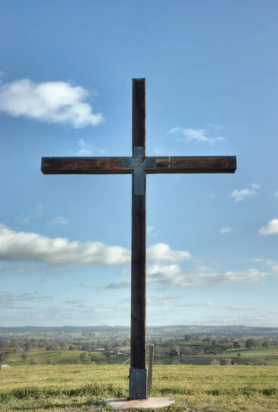 Christian cross of christ in field — Stock Photo, Image