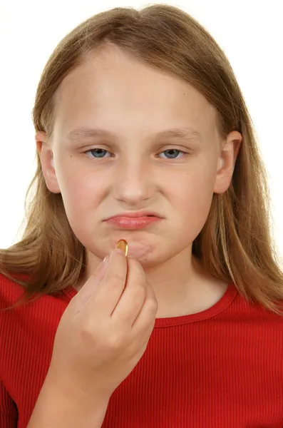 Young girl taking a pill — Stock Photo, Image