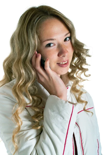 Flicka i vit jacka med mobiltelefon — Stockfoto