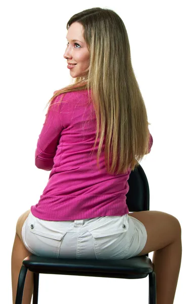 Menina senta-se em uma cadeira — Fotografia de Stock