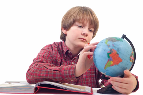 Stock image A young boy with the globe on a white background