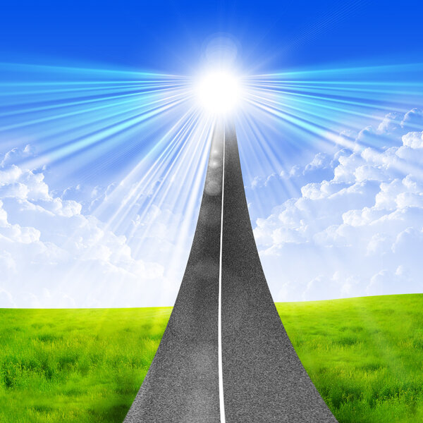 The road stretches into a bright blue sky. symbol of success