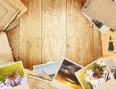 Frame with old paper and photos. Objects over wooden planks clipart