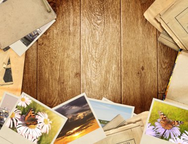 Frame with old paper and photos. Objects over wooden planks clipart