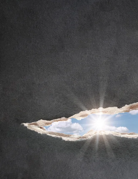 Sun and blue sky in hole — Stock Photo, Image