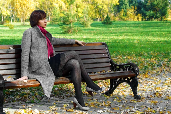 Dívka v parku na lavičce — Stock fotografie