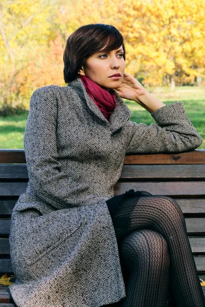 stock image Woman in the autumn forest in the coat