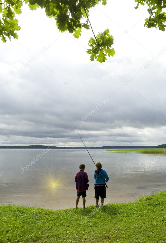 Two boys fishing the sun.