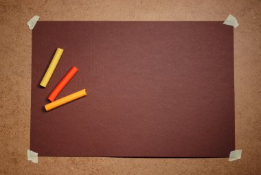 Empty brown cardboard background and multicolored pastel clipart