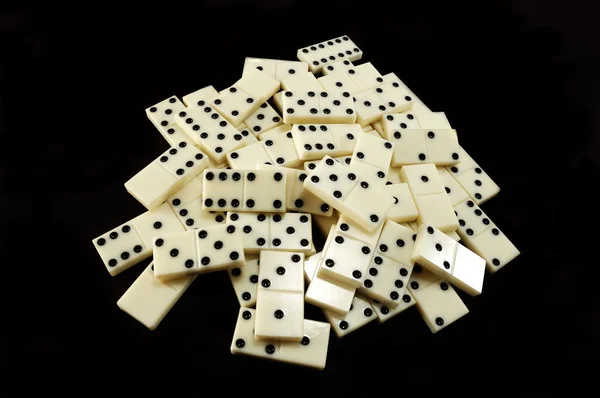 stock image Stack of white dominoes on black background