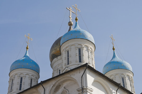 Domes of russian church over blue sky